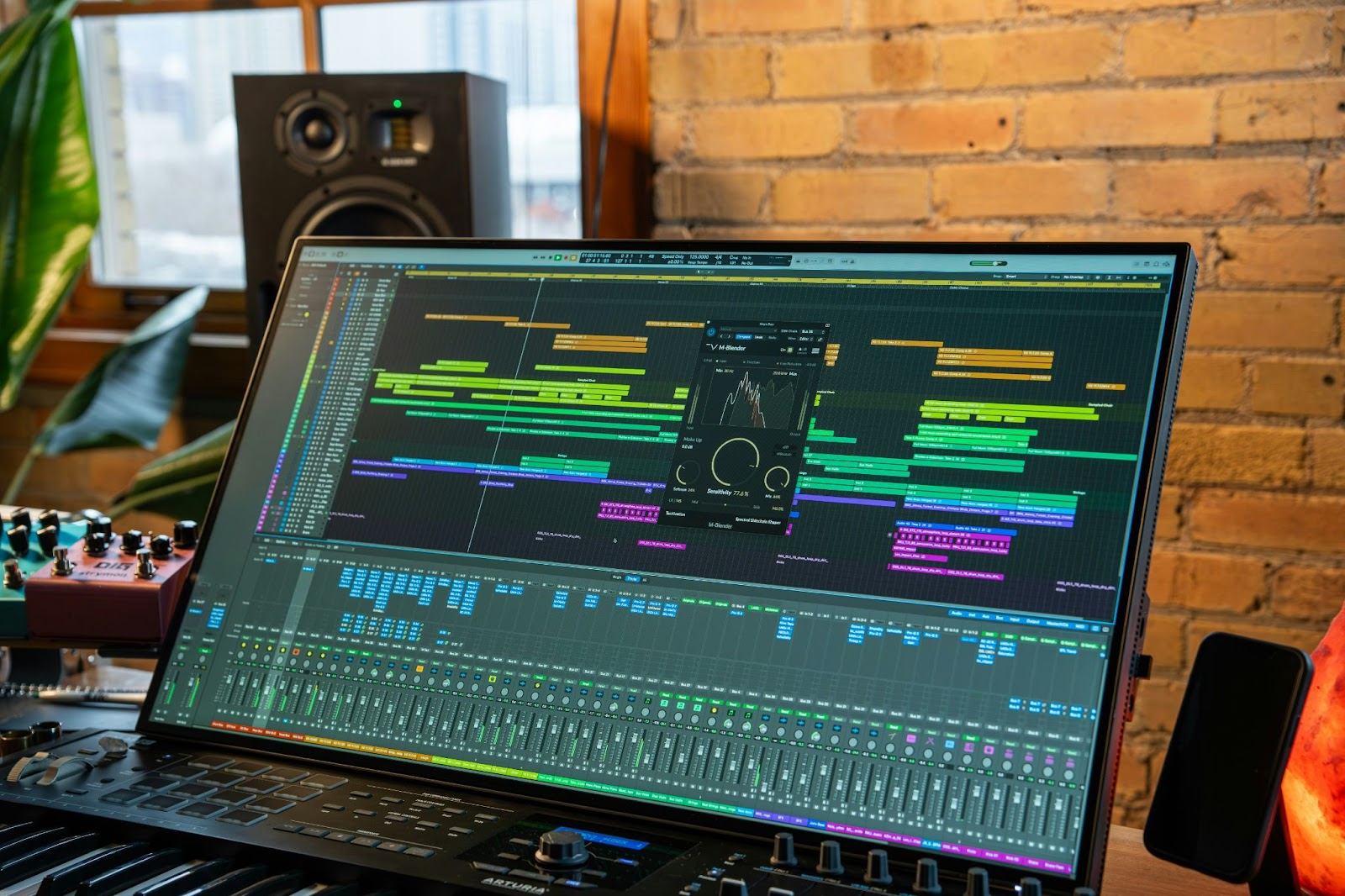 Multitrack audio editing session open on a desktop monitor in a home studio